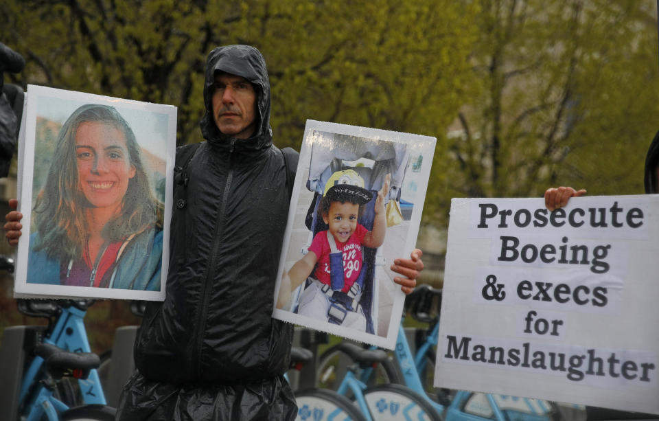 Protester Tarek Milleron holds the photographs of victims in the Ethiopian Airlines Flight 302 plane crash, outside Boeing's annual shareholders meeting at the Field Museum in Chicago on Monday, April 29, 2019 (AP Photo/Jim Young)
