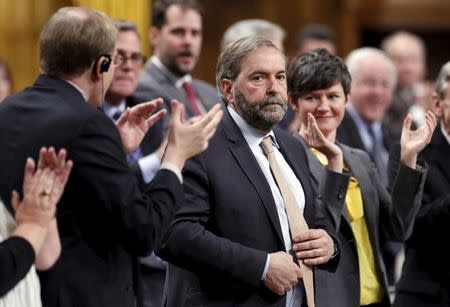 New Democratic Party leader Thomas Mulcair (C) receives a standing ovation from his caucus during Question Period in the House of Commons on Parliament Hill in Ottawa April 22, 2015. REUTERS/Chris Wattie