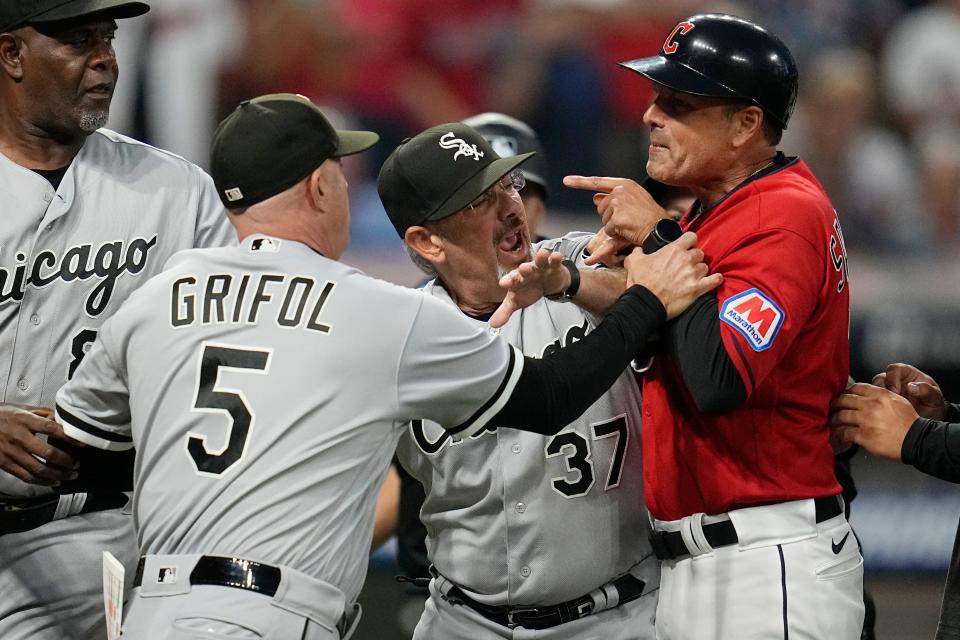 White Sox major league field coordinator Mike Tosar (37) gets between White Sox manager Pedro Grifol (5) and Guardians third base coach Mike Sarbaugh, right, in the sixth inning Saturday.