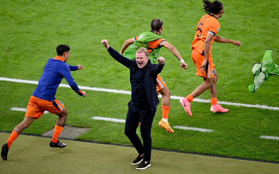 <span>Ronald Koeman punches the air at the final whistle of the Netherlands’ 2-1 quarter-final victory against Turkey.</span><span>Photograph: Fabian Bimmer/Reuters</span>