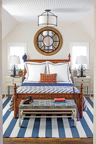 Photo: Laurey W. Glenn This nautical room has the crispness of a blue blazer. A striped rug keeps it casual, the round mirror adds polish, and the bamboo bed imparts that hit of preppiness. Bunny says, &#34;This room would work well for all ages.&#34; <em>The designer recently added this and other beds to her Bunny Williams Home furniture line.</em>