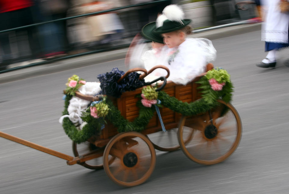 <p>Chuldren ride in a carriage in the Oktoberfest parade. (Reuters/Michael Dalder) </p>