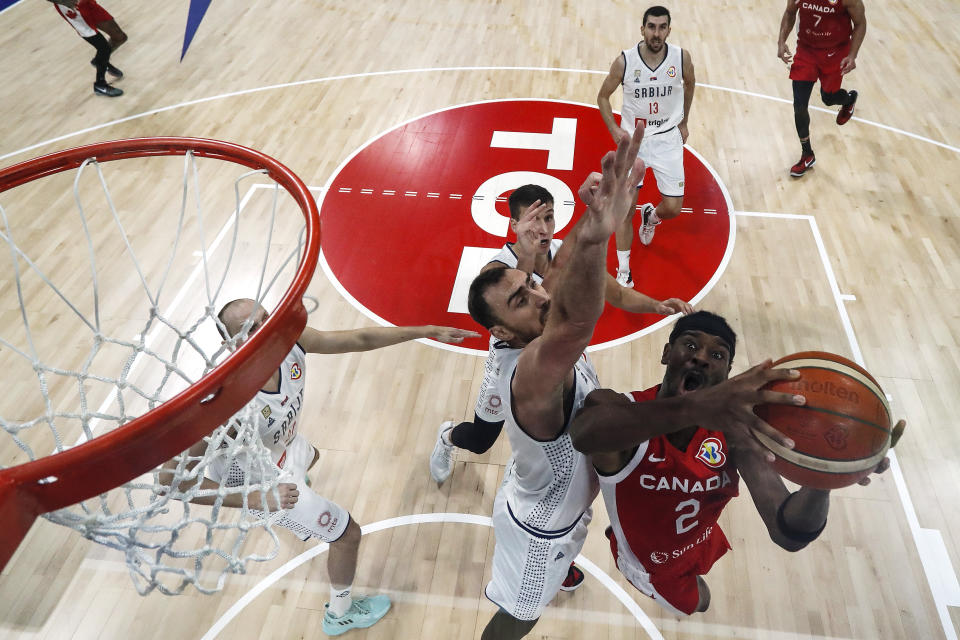 MANILA, PHILIPPINES – SEPTEMBER 08: Shai Gilgeous-Alexander #2 of Canada drives to the basket against Nikola Milutinov #33 of Serbia in the second half during the FIBA Basketball World Cup semifinal game at Mall of Asia Arena on September 08, 2023 in Manila, Philippines. (Photo by Yong Teck Lim/Getty Images)