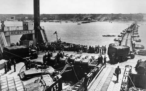 Construction of a Mulberry Harbour, and the unloading of supplies for the Allies at Colleville, France - Credit: Hulton Archive