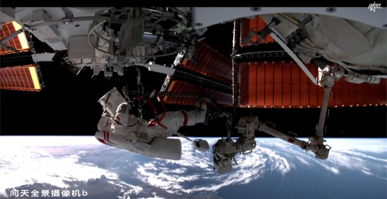  One of China's Shenzhou 15 astronauts works outside the Tiangong space station during the mission's third spacewalk, which the nation revealed on March 30, 2023. 