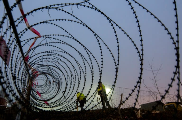 A barbed wire fence is erected at a border crossing between Austria and Slovenia at Spielfeld, Austria in December 2015