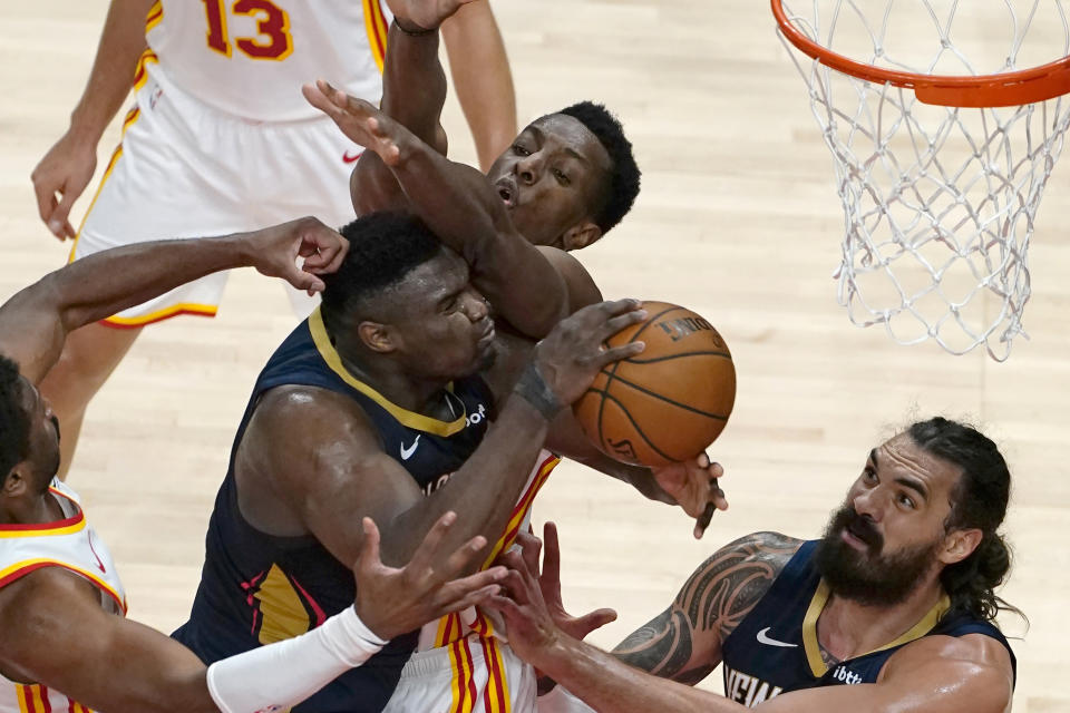 New Orleans Pelicans forward Zion Williamson (1) tries to get to the basket as Atlanta Hawks forward Onyeka Okongwu (17) defends in the first half of an NBA basketball game Tuesday, April 6, 2021, in Atlanta. (AP Photo/John Bazemore)