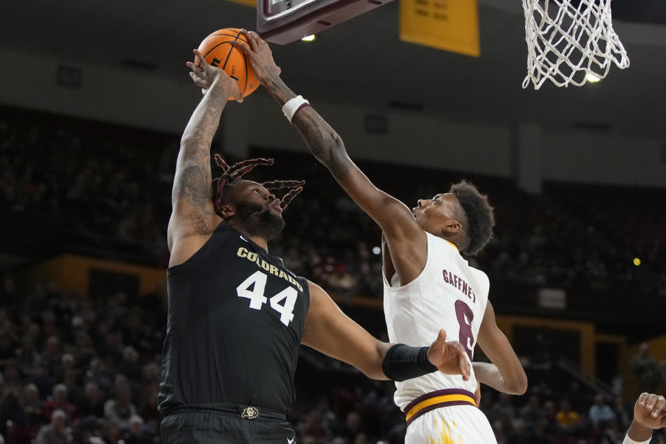 Colorado center Eddie Lampkin Jr. (44) has his shot blocked by Arizona State forward Alonzo Gaffney during the first half of an NCAA college basketball game Saturday, Jan. 6, 2024, in Tempe, Ariz. (AP Photo/Rick Scuteri)