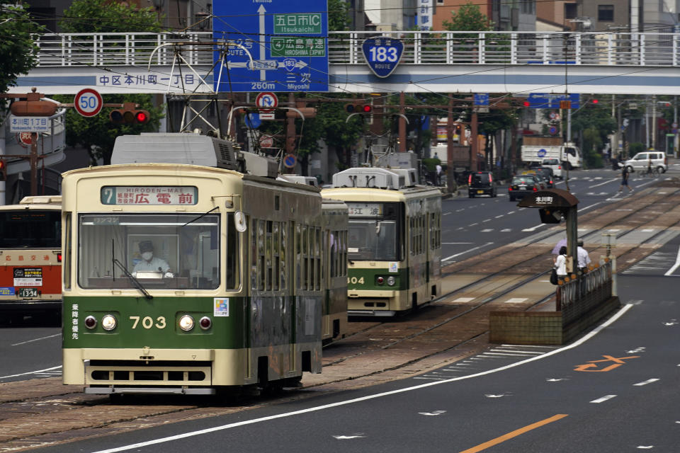 Trams are seen on a street in Hiroshima, western Japan, Monday, Aug. 3, 2020. A tram which survived the Hiroshima atomic bombing will run, without any passenger, on the streets on Aug. 6 to commemorate the day of atomic bombing in the city. (AP Photo/Eugene Hoshiko)