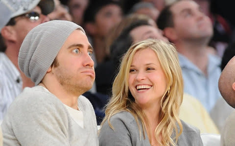 Jake Gyllenhaal with former girlfriend Reese Witherspoon at a Los Angeles Lakers basketball match in 2009 - Credit:  Lisa Blumenfeld/Getty Images 