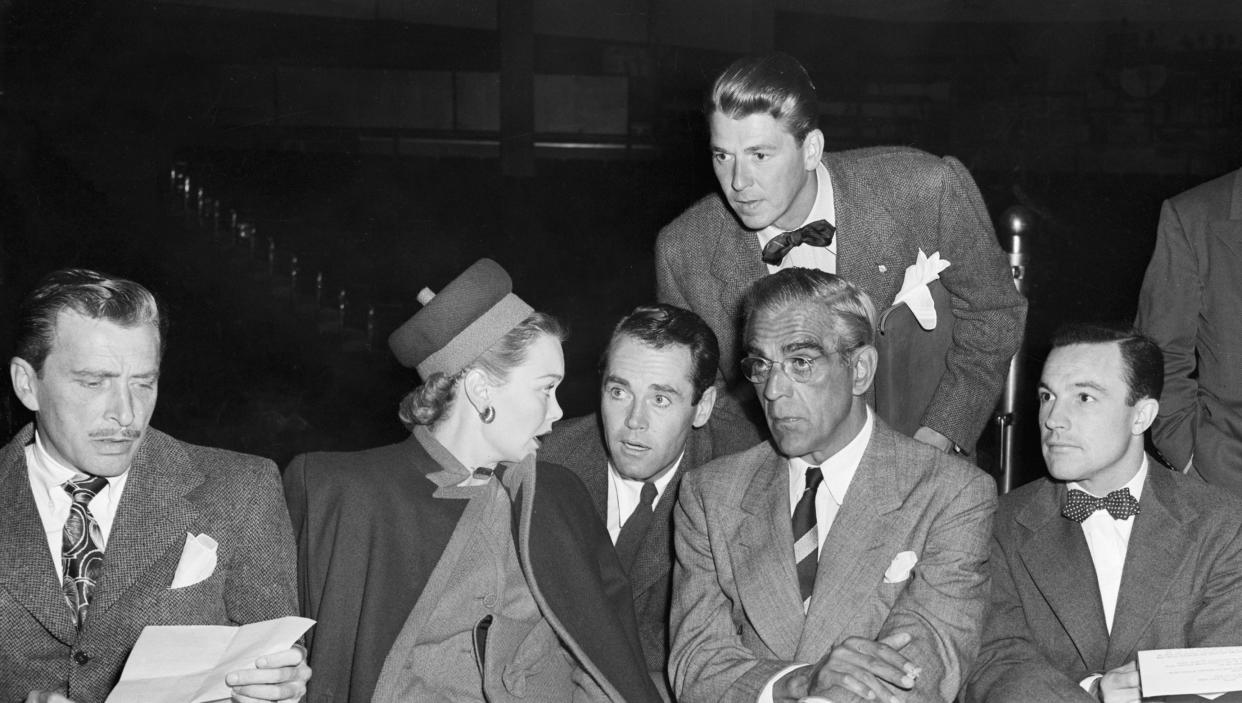 1960s photos of Screen Actors Guild members seated at a table with Ronald Reagan leaning over them.