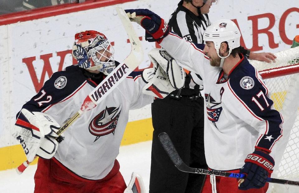 Columbus Blue Jackets goalie Sergei Bobrovsky (72) and center Brandon Dubinsky (17) celebrate after the team defeated the Minnesota Wild 4-2 during an NHL hockey game Saturday, Dec. 31, 2016, in St. Paul, Minn. (AP Photo/Andy Clayton-King)