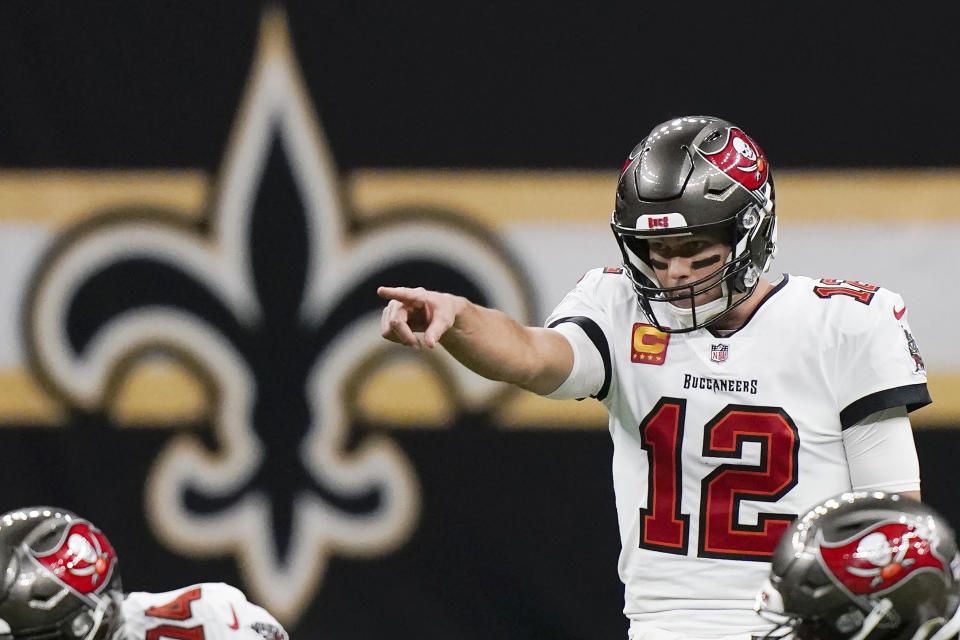 Tampa Bay Buccaneers quarterback Tom Brady (12) signals at the line of scrimmage against the New Orleans Saints during the first half of an NFL divisional round playoff football game, Sunday, Jan. 17, 2021, in New Orleans. (AP Photo/Brynn Anderson)
