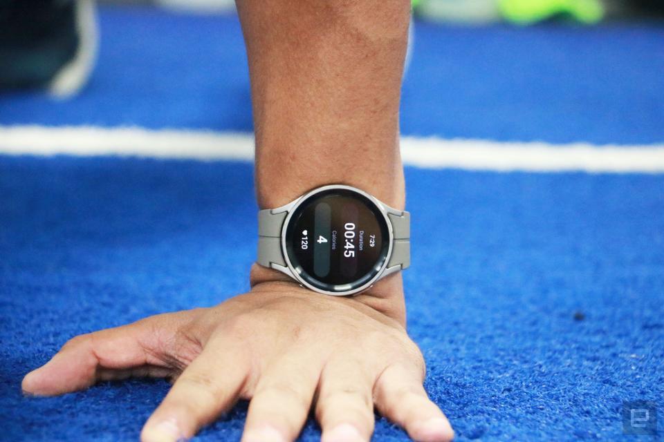 <p>The Samsung Galaxy Watch 5 Pro on the wrist of a person performing a pushup. The camera angle is straight on, and some blue turf can be seen in the picture.</p>
