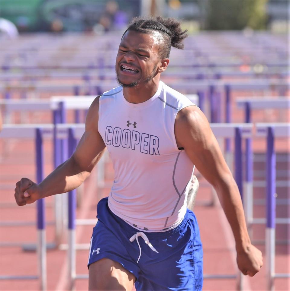 Abilene Cooper's Lawrence Diles crosses the finish line first in the 110 hurdles at the District 4-5A track and field meet April 14 at Sandifer Stadium in Abilene.