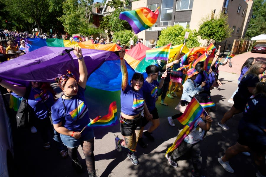 Participants take part in the Pride parade through the streets of downtown Sunday, June 25, 2023, in Denver. (AP Photo/David Zalubowski)