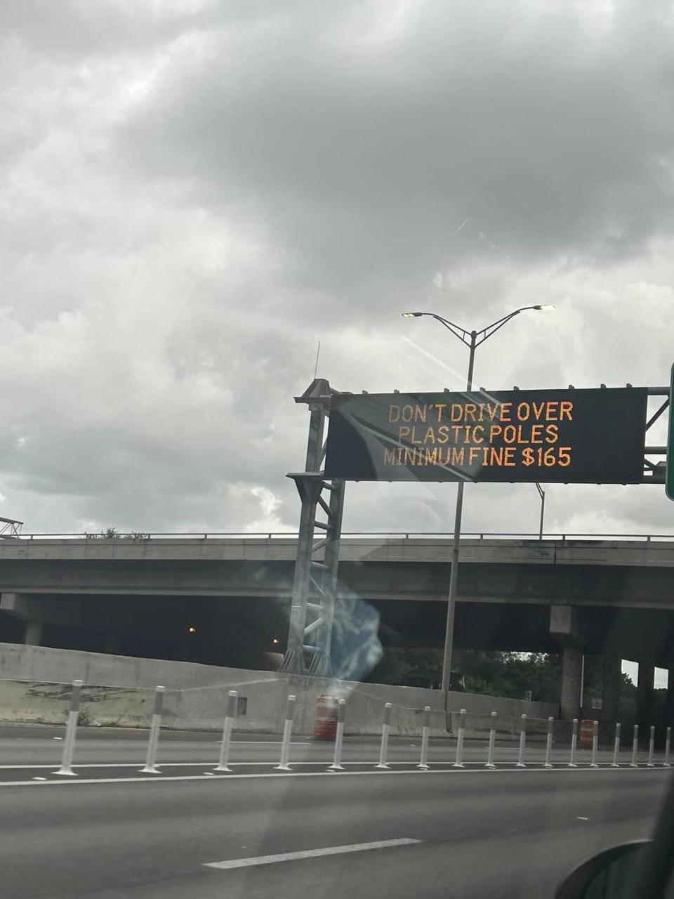 An elctronic sign on a stretch of I-95 in Broward warns drivers not to run over the poles.