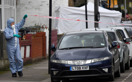 A forensic investigator stretches police tape across Chalgrove Road, where a teenage girl was murdered, in Tottenham, Britain, April 3, 2018. REUTERS/Toby Melville