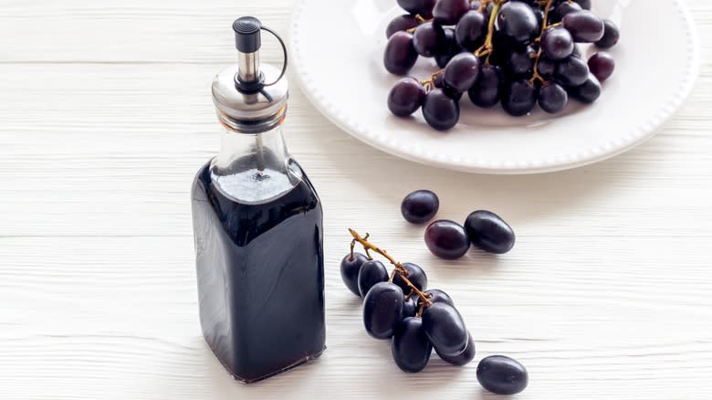 Bottled balsamic vinegar and grapes