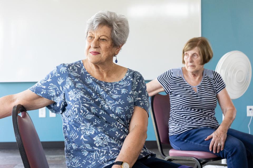 Pam Sadler, left, and Sharron Lovato use their chairs for a twist during a yoga class at the Midvale Senior Center in Midvale on Friday, June 30, 2023. Yoga is an activity that’s good for the brain and the body, experts say. 