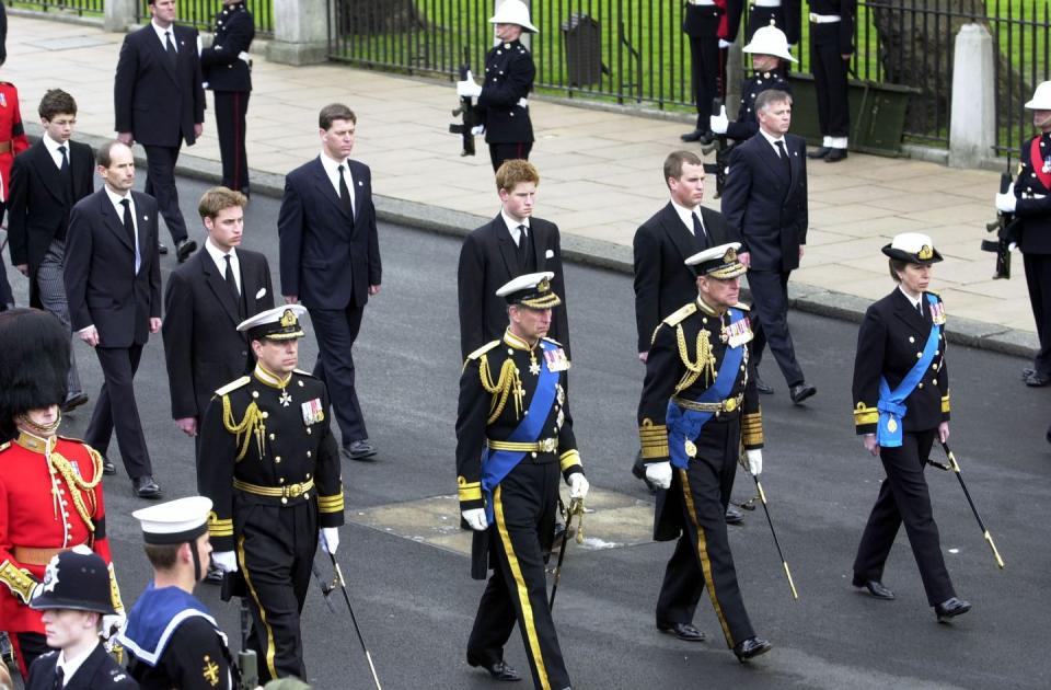 members of the royal family in the procession taking the coffin of queen elizabeth the queen mother from westminster hall to westminster abbey for her funeral 