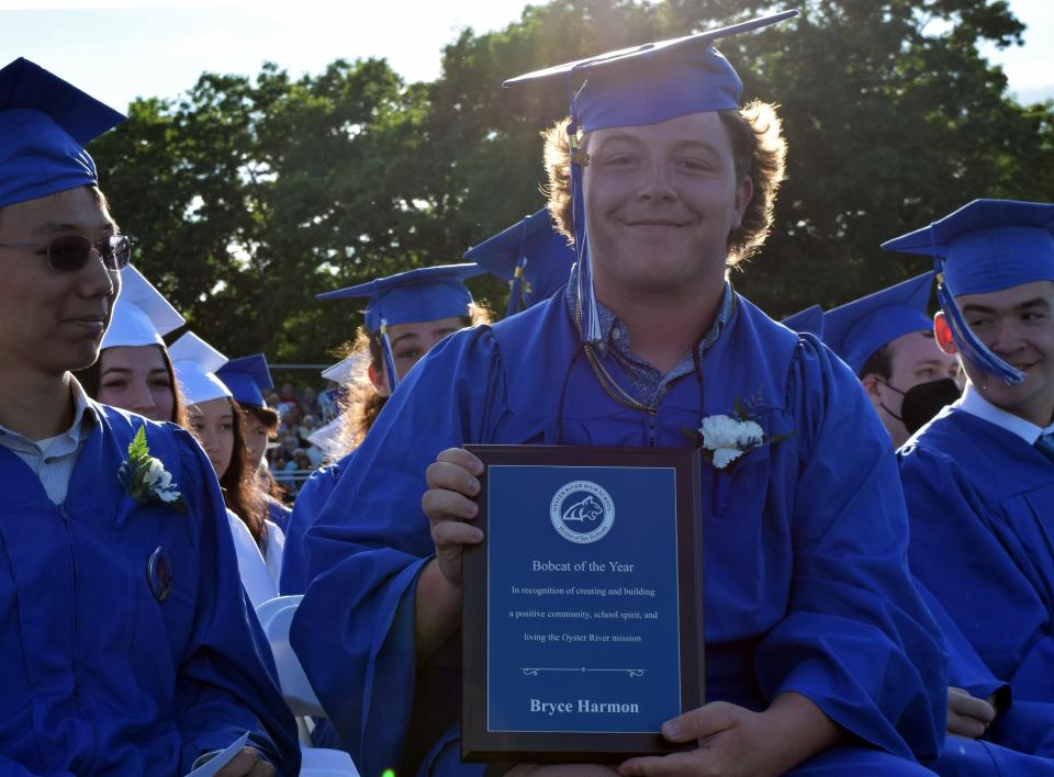 Bryce Harmon holds a plaque in commemoration of being named Oyster River High School's first ever Bobcat of the Year. The award was created this year to recognize a senior for helping to build a positive community and school spirit, and was announced during the Oyster River High School commencement ceremony on Friday, June 10, 2022 at the high school in Durham.