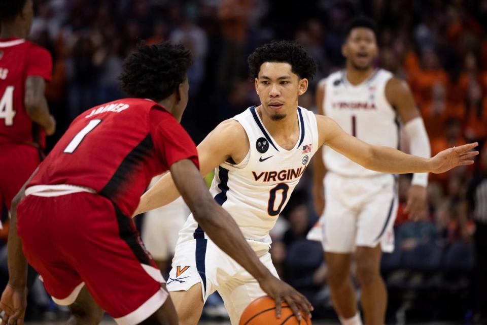 North Carolina State’s Jarkel Joiner (1) is defended by Virginia’s Kihei Clark (0) during the second half of an NCAA college basketball game in Charlottesville, Va., Tuesday, Feb. 7, 2023. (AP Photo/Mike Kropf)