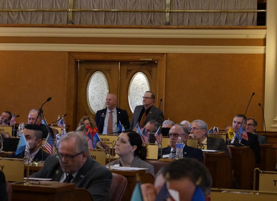 Sen. Jim Mehlhaff, R-Pierre, and Sen. Brent Hoffman, R-Sioux Falls, listen to House debate on SB 146. Hoffman sponsored 146 which would change sentencing guidelines for violent offenders.