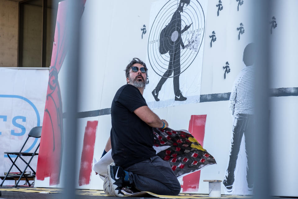 Manuel Oliver, whose son, Joaquin, was killed at the school shooting in Parkland, Florida, this year, creates a mural at the Rally 4 Reform at Dallas City Hall on&nbsp;Saturday.