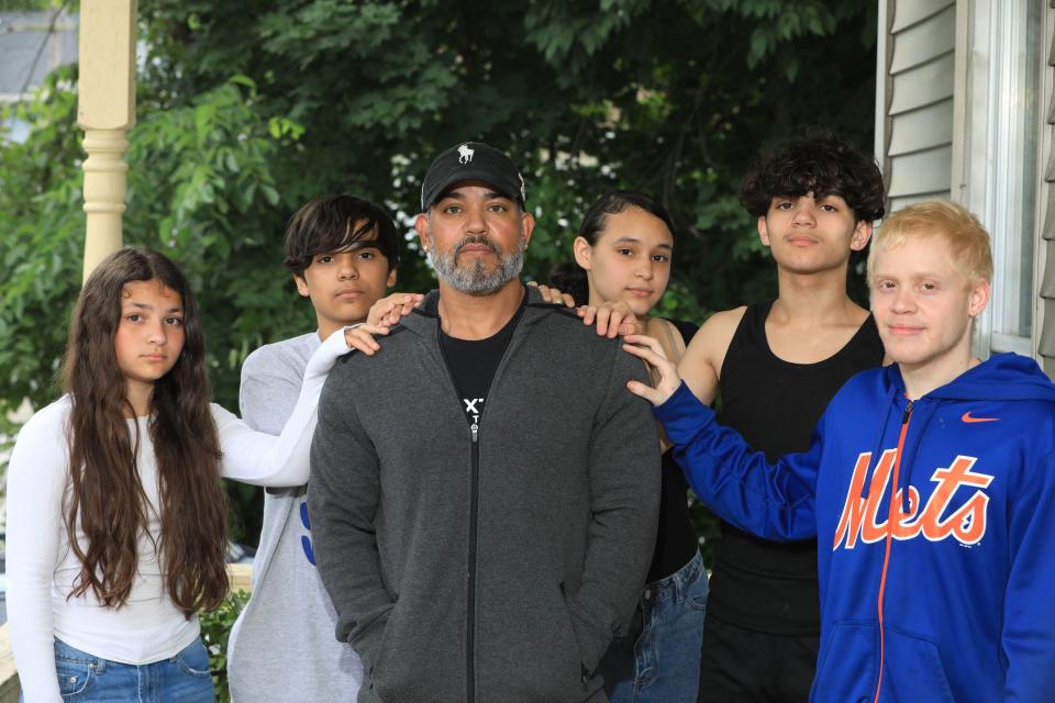 Eric Alvarez with his family outside their home in Walden, NY on June 21, 2022.