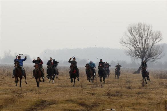 Men ride their horses during the annual race organized by Orthodox believers on Epiphany Day in the Romanian village of Pietrosani, north of Bucharest, January 6, 2012. REUTERS/Bogdan Cristel