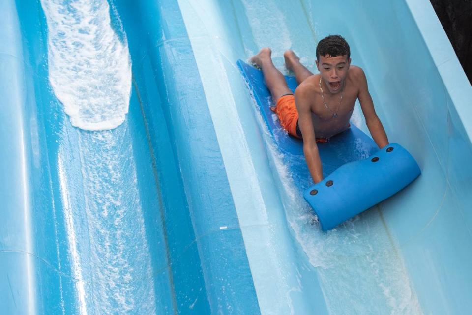 A child rides on the water slide at the OWA Tropic Falls water park in Foley, Alabama.