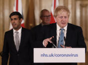 FILE - In this file photo dated Tuesday, March 17, 2020, Britain's Chancellor Rishi Sunak, left, and Prime Minister Boris Johnson arrive for a press briefing about the ongoing situation with the COVID-19 coronavirus outbreak, inside 10 Downing Street in London. With British Prime Minister Boris Johnson hospitalized and in intensive care Wednesday April 8, 2020, after contracting the new coronavirus, Sunak is among key players in Johnson's Cabinet who will be directing Britain's response to the highly contagious COVID-19 coronavirus, while their leader is being treated. (AP Photo/Matt Dunham, FILE)