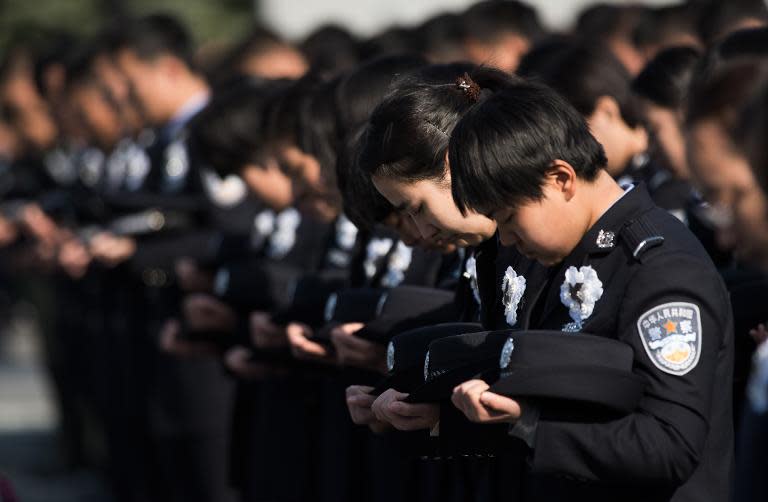 Police officers attend a memorial ceremony on China's first National Memorial Day for Nanjing Massacre Victims in Nanjing city on December 13, 2014