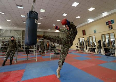 Fatima Rezai, 21, a female officer from the Afghan National Army (ANA) practices with a punch bag during an exercise session at at the Kabul Military Training Centre (KMTC) in Kabul, Afghanistan October 23, 2016. REUTERS/Mohammad Ismail
