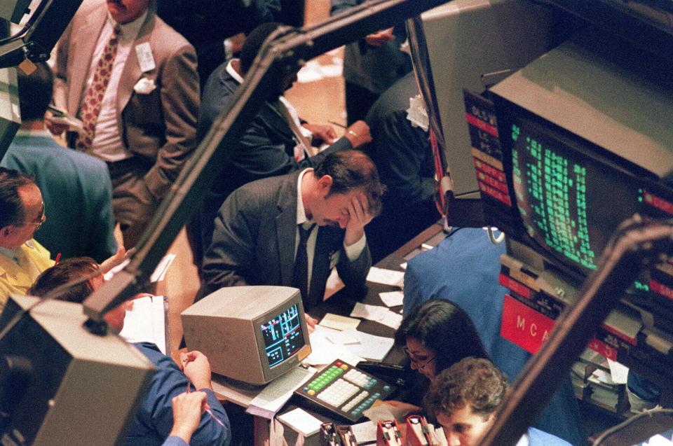 Picture taken 19 October 1987 shows a trader holding his head at the floor of the New York Stock Exchange when the Dow Jones dropped over 500 points, the largest decline in modern time, as panic selling swept Wall Street. The 19 October 2007 marks the 20th anniversary of the so-called "Black Monday", when the Dow Jones Industrial Average stock barometer plunged a dramatic 22.61 percent to 1,738.41 points.  