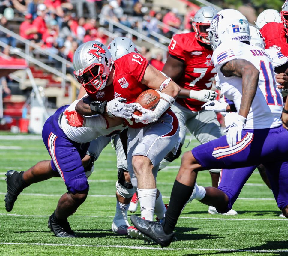 Nicholls running back Collin Guggenheim (19) runs through Northwestern State defenders during a Southland Conference game in Thibodaux on Oct. 30.