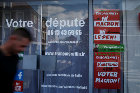 A man walks past the local headquarters of Francois Ruffin, a member of parliament of political party " La France Insoumise" (France Unbowed), in Amiens, France, May 16, 2019. Picture taken May 16, 2019. REUTERS/Pascal Rossignol