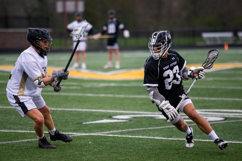 West Ottawa's Cole Tulgestke takes the ball up the field Thursday, May 5, 2022, at Zeeland High School.