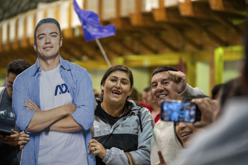 Supporters of candidate Daniel Noboa have their photo taken as they celebrate with a cardboard cutout, his victory in the runoff presidential election, in Quito, Ecuador, Sunday, Oct. 15, 2023. (AP Photo/Carlos Noriega)