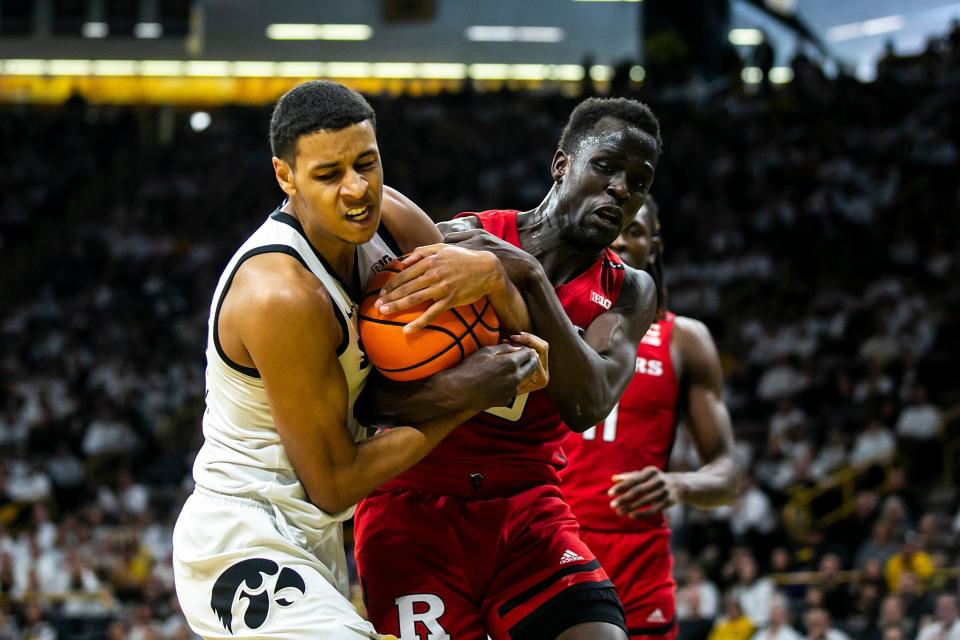 Iowa forward Kris Murray, left, fights for a rebound against Rutgers forward Mawot Mag during a NCAA Big Ten Conference men's basketball game, Sunday, Jan. 29, 2023, at Carver-Hawkeye Arena in Iowa City, Iowa.