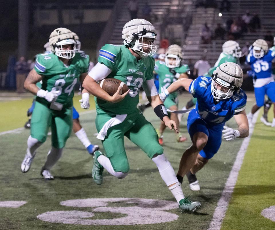 Quarterback Brett Nezat (13) keeps the ball during the spring football game at the University of West Florida in Pensacola on Thursday, March 9, 2023.