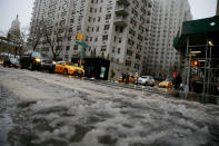 <p>The streets are layered in icy mixture of snow and rain as traffic moves down Broadway in New York City, March 7, 2018. (Photo: Gordon Donovan/Yahoo News) </p>