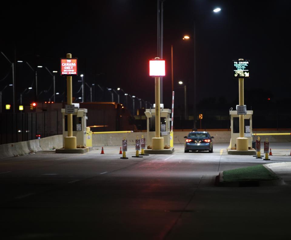 A vehicle waits at the toll booth to cross the Ambassador bridge in Detroit on Monday, August 9, 2021. Canada reopened its borders to the United States on Monday, allowing for fully vaccinated U.S. citizens and permanent residents to cross the border.