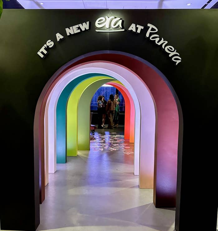 Entrance to Panera featuring a multilayered archway with "It's a New Era at Panera" text