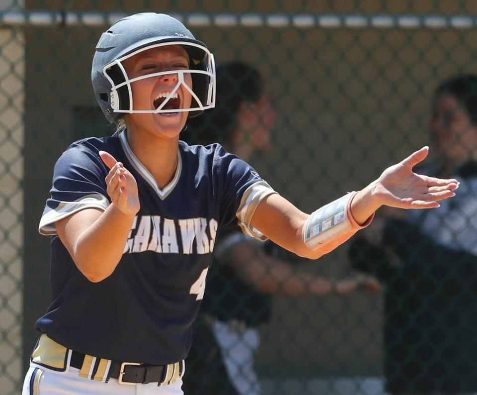 Delaware Military's Annika Downs score and cheers teammate Marisa Edevane's two-rbi single that tied the game in the fifth inning of DMA's 8-4 win Saturday, April 30, 2022 at St. Mark's.