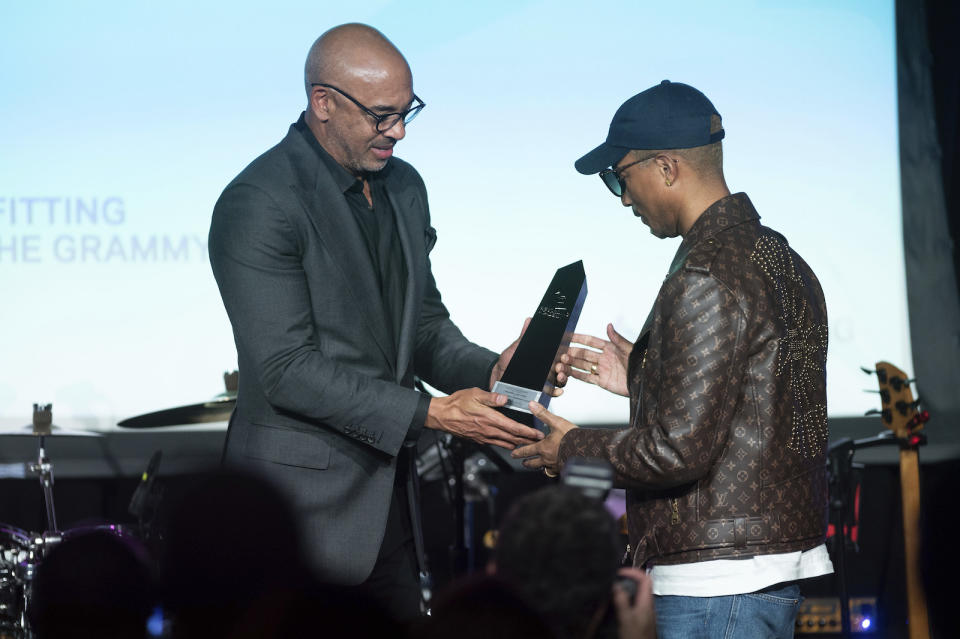 Recording Academy CEO Harvey Mason, jr., presents Pharrell Williams with the Creators Leadership Award during the GRAMMYs on the Hill Awards on Wednesday, April 26, 2023, at The Hamilton in Washington. (Photo by Kevin Wolf/Invision/AP)