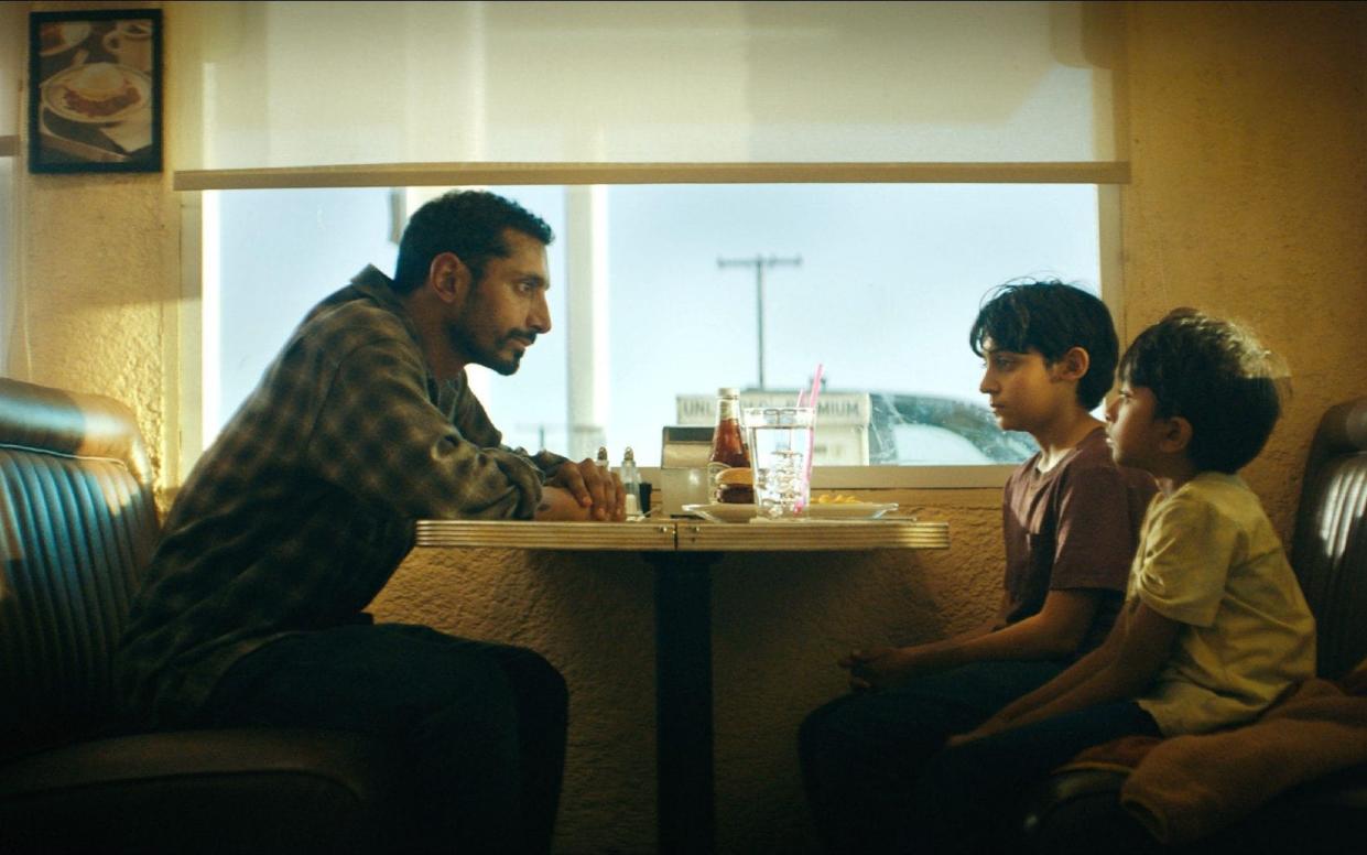 Riz Ahmed, Lucian-River Chauhan and Aditya Geddada in a scene from Encounter - Amazon Studios/The Hollywood Archive/Alamy