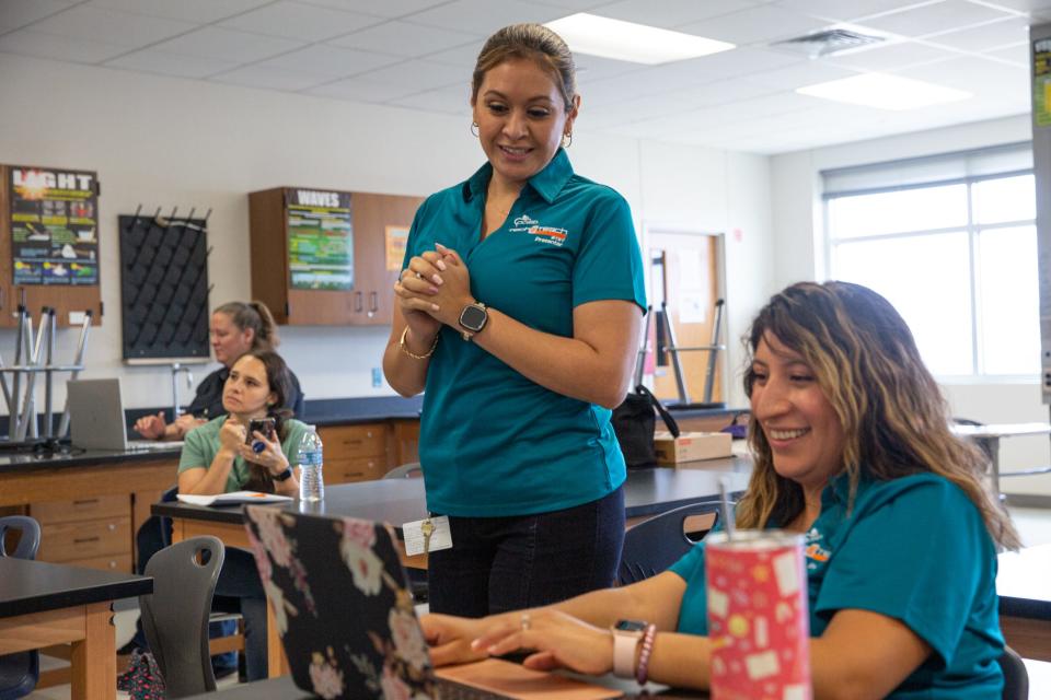 Veronica Gonzales, a CTE specialist, watches Michelle Irujo, an counselor at Mireles Elementary, compete in a computer game and quiz with others in the seminar, during CCISD's Tech2Teach, a conference on technology in the classroom, on Wednesday, July 19, 2023, in Corpus Christi, Texas.