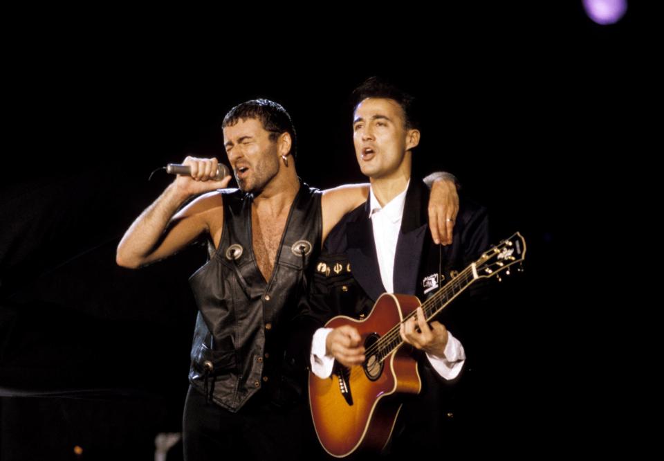 BRAZIL - JANUARY 27:  ROCK IN RIO III  Photo of Andrew RIDGELEY and George MICHAEL and WHAM!, Andrew Ridgeley (playing Yamaha acoustic guitar) appearing with George Michael at solo performance, performing live onstage  (Photo by Mick Hutson/Redferns)